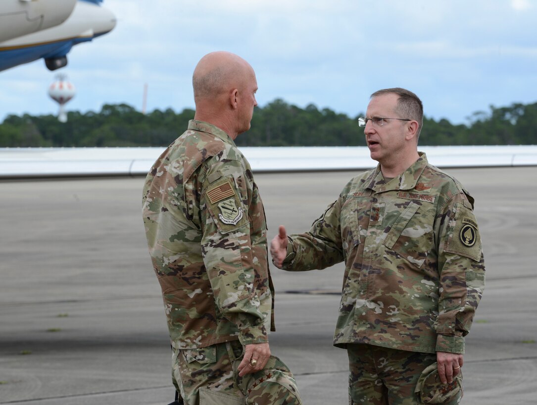 Two people talking on a flightline.