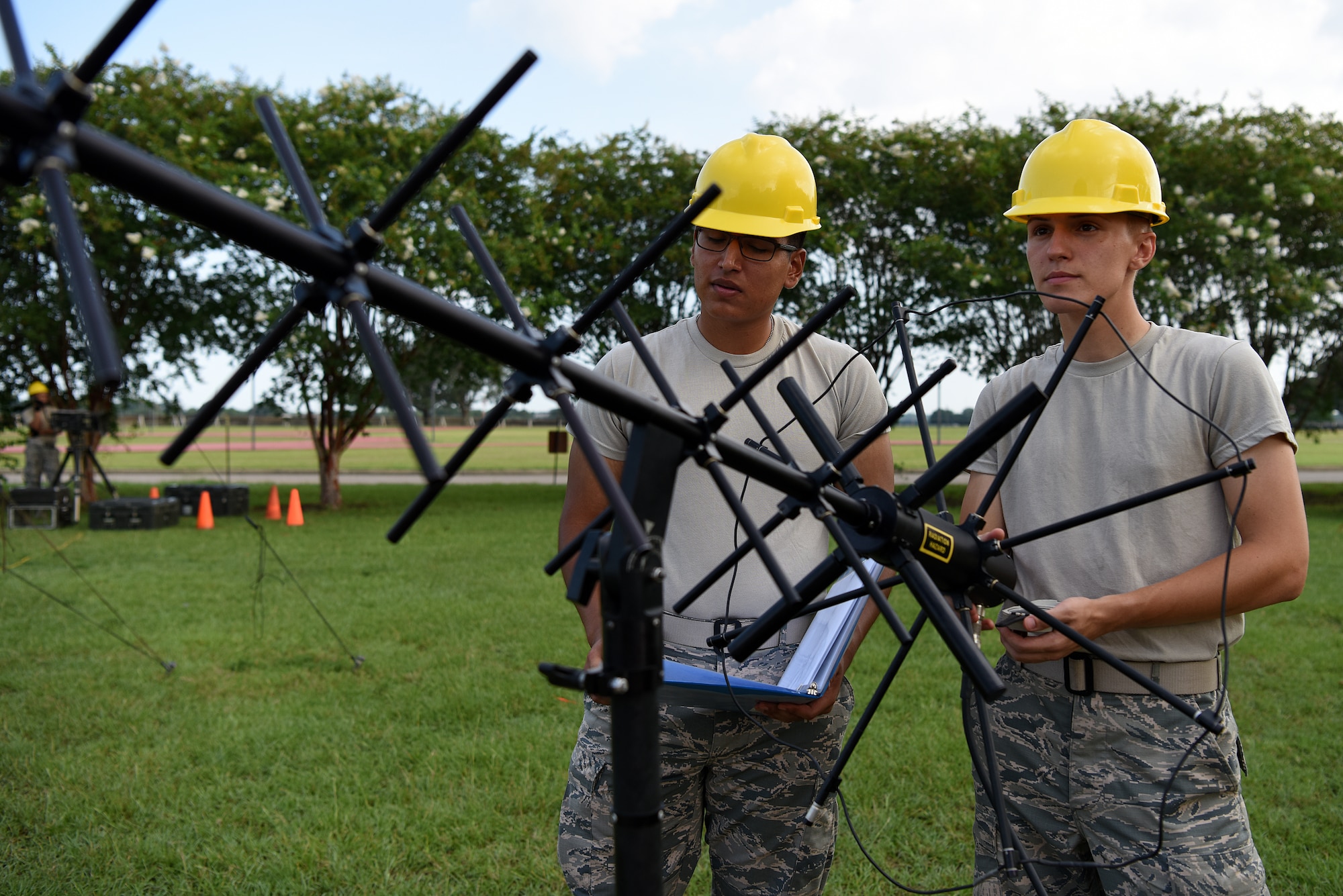 U.S. Air Force Airmen Noah Ruiz and Dante Wolfinger, 338th Training Squadron Radio Frequency Transmission Systems students, set up tactical satellite communication outside of Jones Hall on Keesler Air Force Base, Mississippi, August 12, 2019. The RF Transmission System course is a 653 hour course where students learn line-of-sight communication, high frequency operations, satellite communications and systems and more. (U.S. Air Force photo by Senior Airman Suzie Plotnikov)