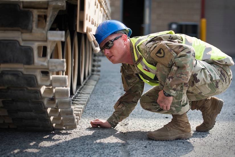 Sgt. 1st Class Matthew Zakrzewski, maintenance quality assurance, 401st Army Field Support Battalion-Kuwait inspects the tracks of a M2 Bradley Fighting Vehicle following repairs Aug. 15 at Army Prepositioned Stocks-5, Camp Arifjan, Kuwait.