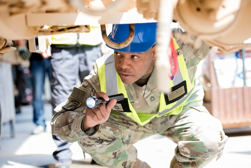 Sgt. 1st Class Roy Carson, maintenance quality assurance for wheeled vehicles, 401st Army Field Support Battalion-Kuwait inspects the undercarriage of a PLS 1076 trailer before certifying the contractor’s repairs Aug. 10 at Army Prepositioned Stocks-5, Camp Arifjan, Kuwait.