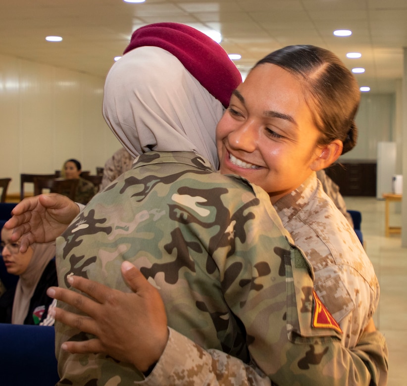 U.S. Marine Corps Sgt. Elia Balbaloza (right), with 11th Marine Expeditionary Unit Female Engagement Team (FET), thanks a member of the Jordan Armed Forces-Arab Army Quick Reaction Force (FET) with a hug after an exchange of gifts following the closing ceremony for the subject matter exchange between the two countries August 7, 2019. The U.S. is committed to the security of Jordan and to partnering closely with JAF to meet common security challenges.