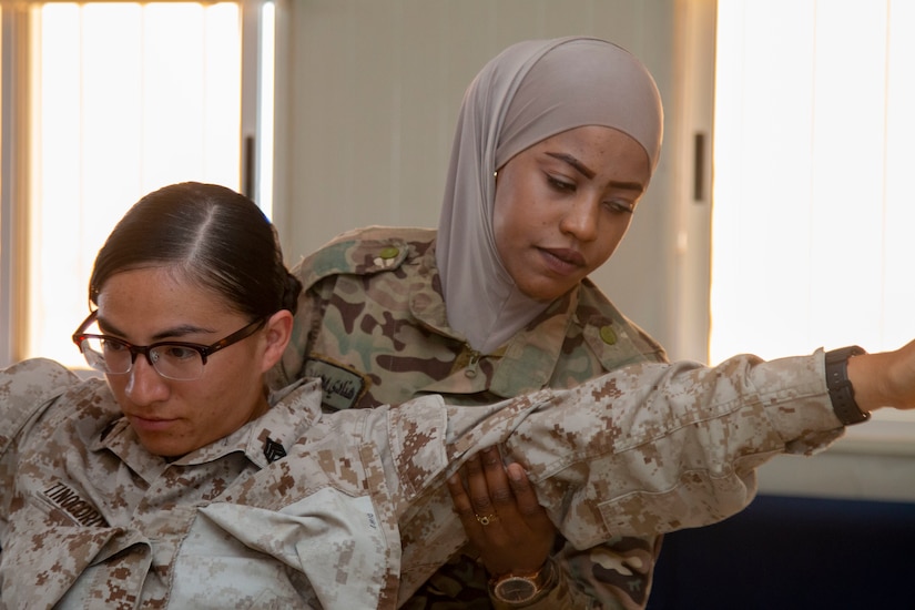 Madaba resident Pvt. Hanady Al-Shakhatreh (right), with Jordan Armed Forces-Arab Army Quick Reaction Force Female Engagement Team (FET), practices physical search procedures on U.S. Marine Corps Sgt. Maricela Tinocoromero, with 11th Marine Expeditionary Unit FET, during detainee operations and handling training August 5, 2019 in Jordan. The U.S. is committed to the security of Jordan and to partnering closely with JAF to meet common security challenges.