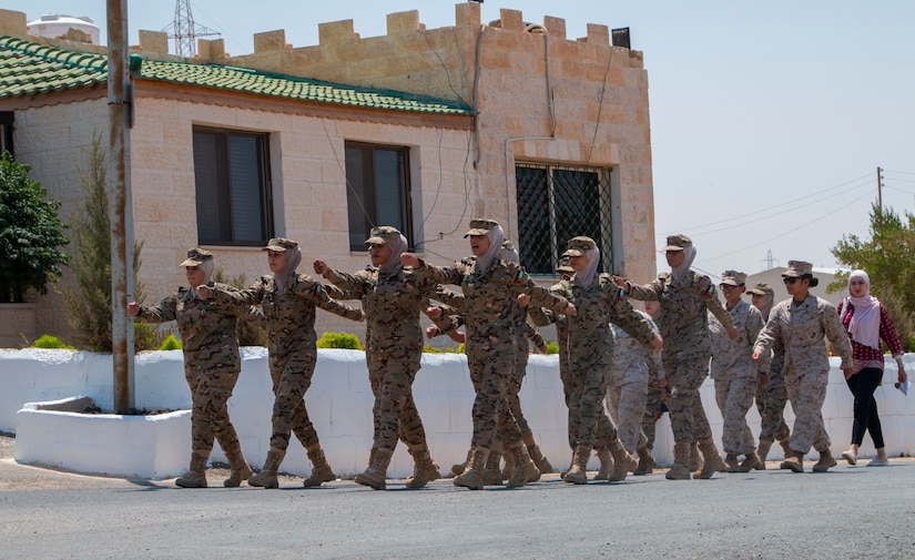 Members of the 11th Marine Expeditionary Unit Female Engagement Team (FET) march alongside the Jordan Armed Forces-Arab Army Quick Reaction Force FET after subject matter expert exchange between the two countries August 5, 2019. The U.S. is committed to the security of Jordan and to partnering closely with JAF to meet common security challenges.