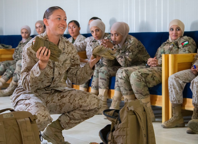 U.S. Marine Corps Cpl. Riley Guidi, with 11th Marine Expeditionary Unit Female Engagement Team (FET), demonstrates how to search a bag during detainee operations and handling training with the Jordan Armed Forces-Arab Army Quick Reaction Team FET August 5, 2019 in Jordan. The U.S. is committed to the security of Jordan and to partnering closely with JAF to meet common security challenges.