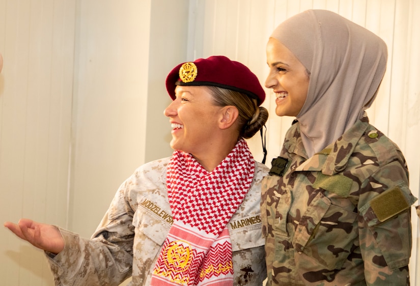U.S. Marine Corps Capt. Katie Modzelewski (left), with 11th Marine Expeditionary Unit Female Engagement Team (FET), smiles after a member of the Jordan Armed Forces-Arab Army Quick Reaction Force (FET) positions one of their beret’s on her to show their appreciation and unity following the closing ceremony for the subject matter exchange between the two countries August 7, 2019. The U.S. is committed to the security of Jordan and to partnering closely with JAF to meet common security challenges.