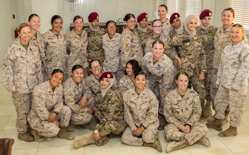 Members of the 11th Marine Expeditionary Unit Female Engagement Team (FET) and the Jordan Armed Forces-Arab Army Quick Reaction Force FET pose together for a group photo following the closing ceremony for the subject matter exchange between the two countries August 7, 2019. The U.S. is committed to the security of Jordan and to partnering closely with JAF to meet common security challenges.