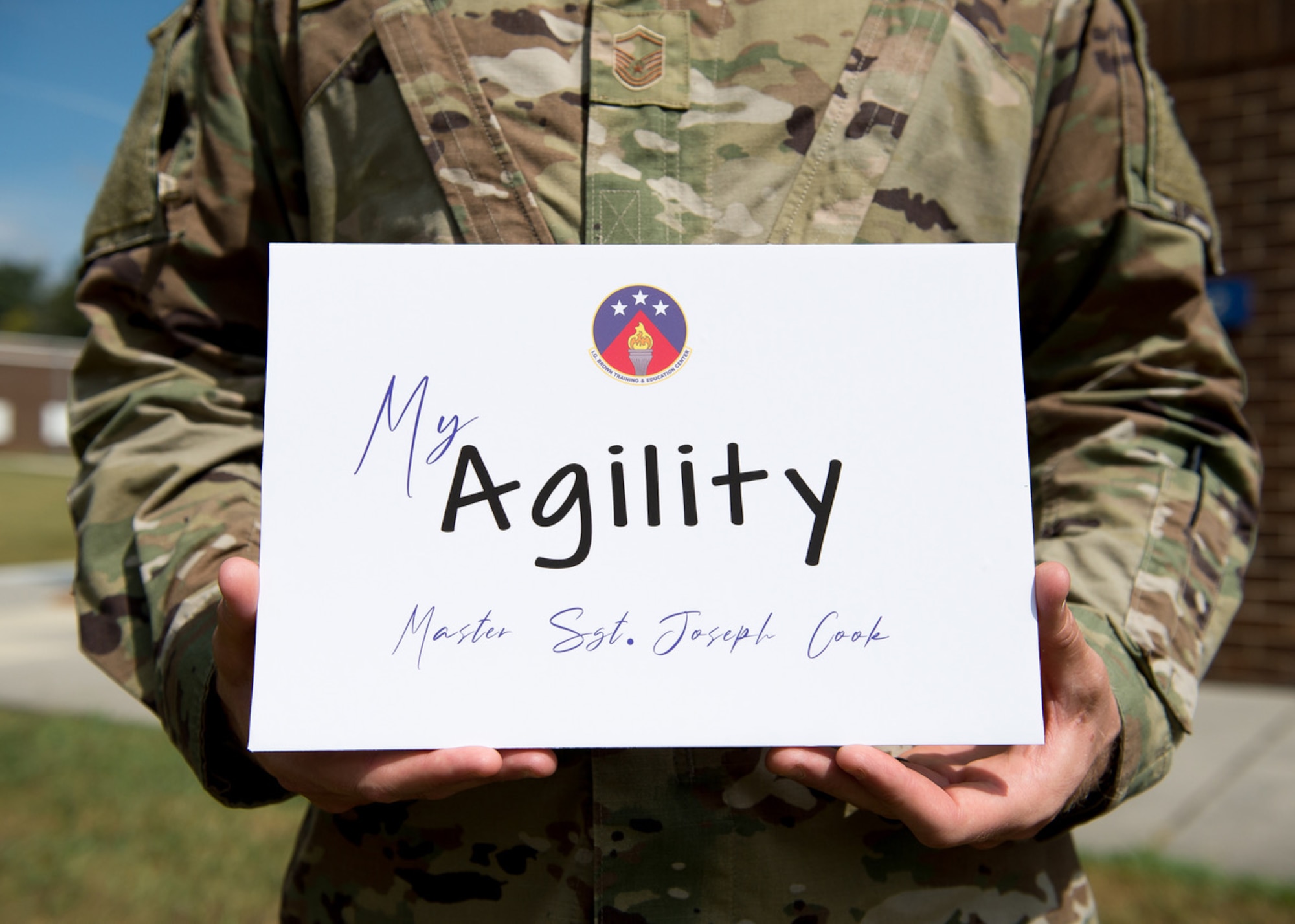 Airman holding sign