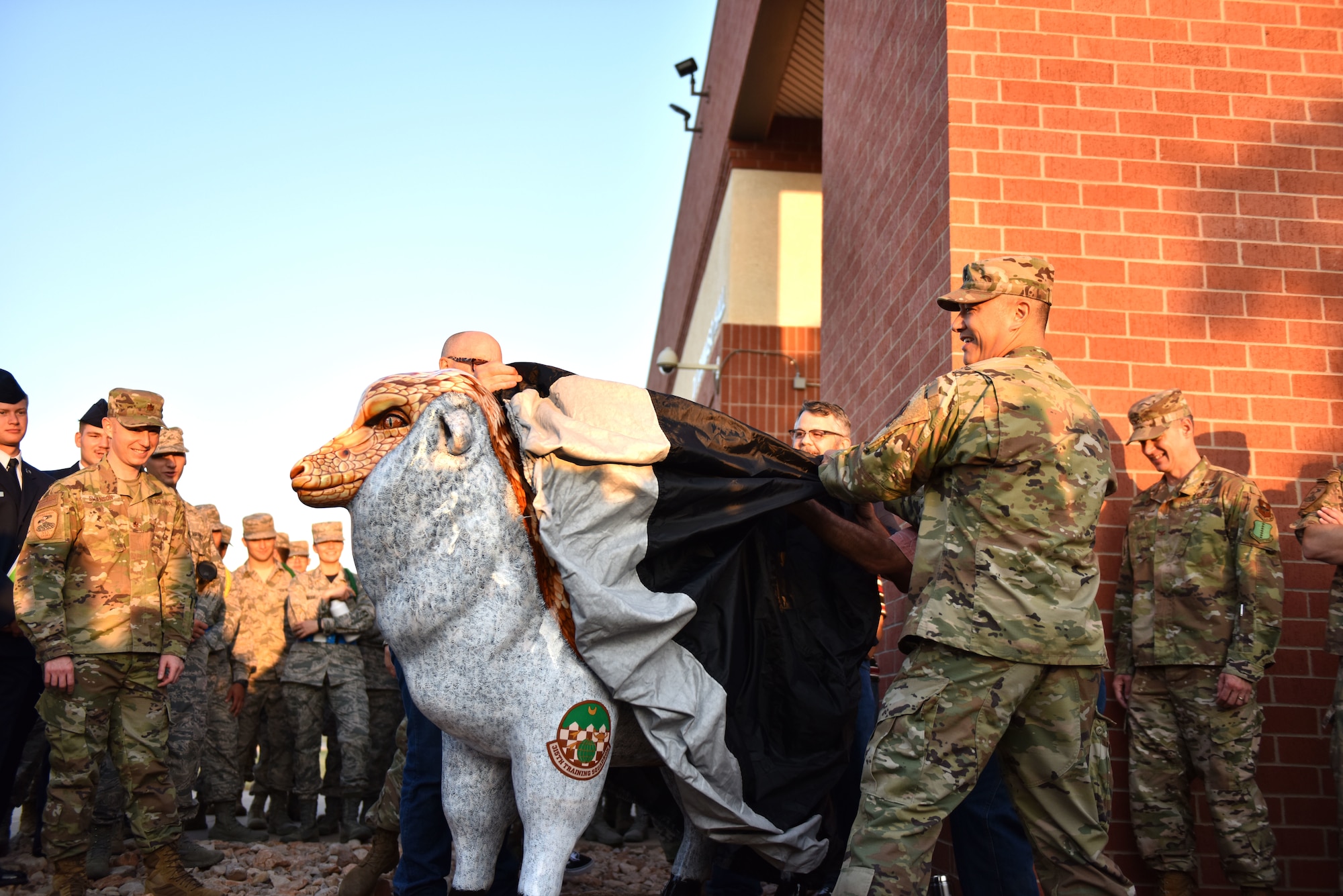 U.S. Air Force Lt. Col. Mark Chang, 315th Training Squadron commander, unveils the new fiberglass sheep located in front of Di Tommaso Hall on Goodfellow Air Force Base, Texas, August 16, 2019. A variety of fiberglass sheep are located all around San Angelo in recognition of time known as the wool capitol of the world. (U.S. Air Force photo by Senior Airman Seraiah Wolf/Released)
