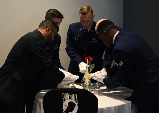 Graduates of Airman Leadership School set the POW/MIA table prior to the ALS Graduation ceremony at the event center on Goodfellow Air Force Base, Texas, August 22, 2019. The table was set as a symbol of honor and remembrance of America’s prisoners of war and missing comrades across all branches. (U.S. Air Force photo by Airman 1st Class Robyn Hunsinger/Released)