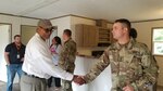 Homeowner Herman James of London, W.Va., thanks West Virginia National Guard Sgt. Taylor Gales, who is working with the RISE program, on Aug. 23, 2019.
Herman and Kay James received keys to their now mobile home, the 59th completed by RISE WV since the 2016 floods, while members of the Guard, West Virginia VOAD and Thompson Construction were in attendance. .