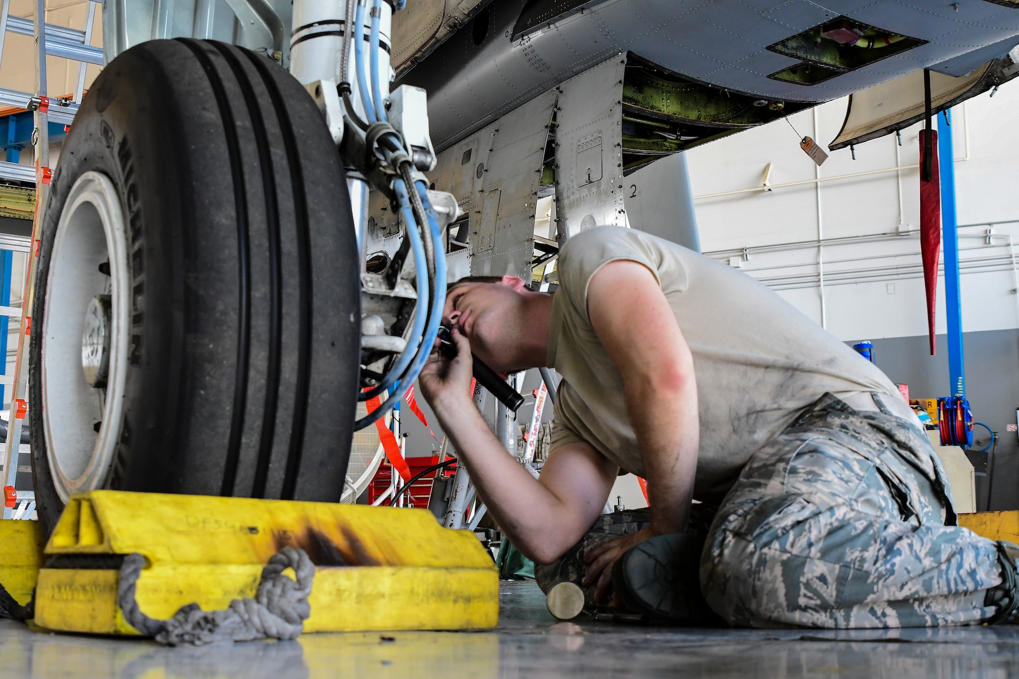 a photo of an airman working on an A-10