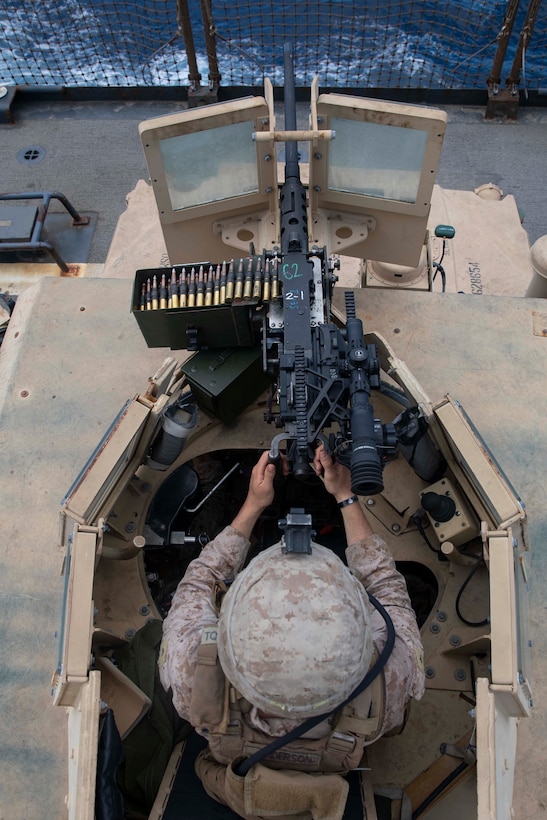 U.S. Marine Lance Cpl. Michael Anderson Jr., a machine gunner with the 22nd Marine Expeditionary (MEU), stands watch in the turret of a Humvee on the flight deck of the Whidbey Island-class amphibious dock landing ship USS Fort McHenry (LSD-43) during the transit through the Bab-El-Mandeb strait, May 21, 2019.