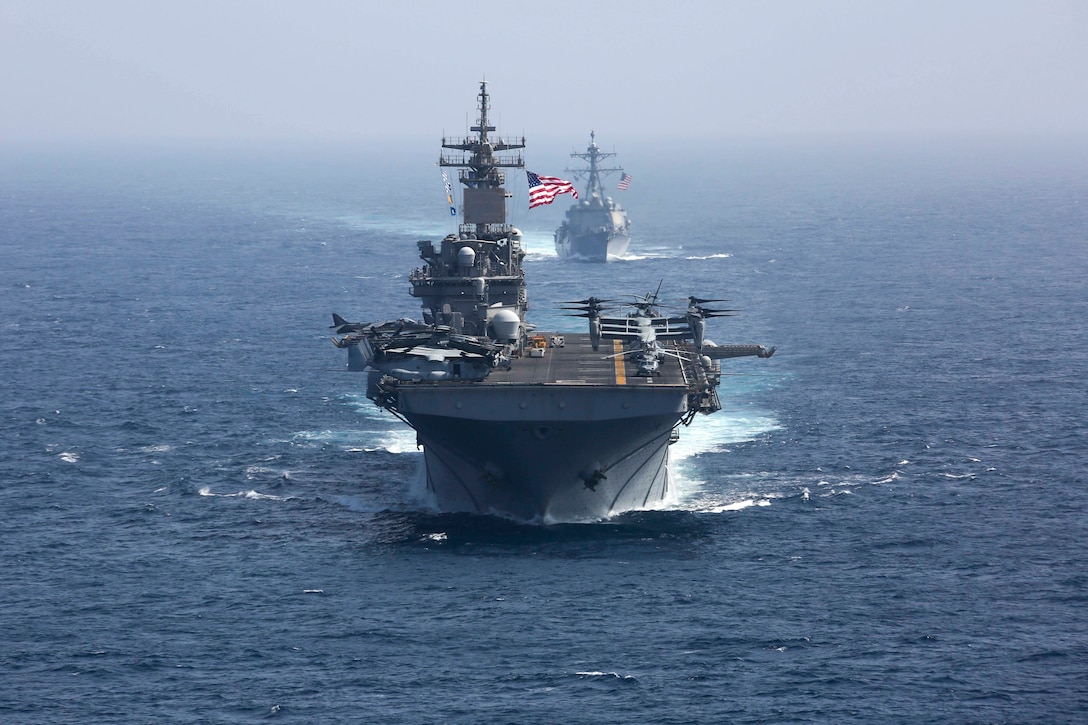 1900517-N-FK070-1248 ARABIAN SEA (May 17, 2019) The Wasp-class Amphibious Assault Ship USS Kearsarge (LHD 3) and the Arleigh Burke-class guided-missile destroyer USS Bainbridge (DDG 96) sail in formation as the Abraham Lincoln Carrier Strike Group (ABECSG) and Kearsarge Amphibious Ready Group (KSGARG) conduct joint operations in the U.S. 5th Fleet area of operations. The ABECSG and KSGARG, with the 22nd Marine Expeditionary Unit, are prepared to respond to contingencies and to defend U.S. forces and interests in the region. (U.S. Navy photo by Mass Communication Specialist 1st Class Brian M. Wilbur/Released)