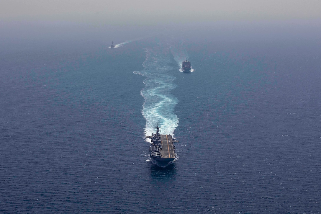 190507-N-YH603-1236 STRAIT OF HORMUZ (May 7, 2019) The Wasp-class amphibious assault ship USS Kearsarge (LHD 3), center, the dry cargo and ammunition ship USNS Alan Shepard (T-AKE 3), right, and the Arleigh Burke-class guided-missile destroyer USS McFaul (DDG 74) transit the Strait of Hormuz. Kearsarge is the flagship for the Kearsarge Amphibious Ready Group and, with the embarked 22nd Marine Expeditionary Unit, is deployed to the U.S. 5th Fleet area of operations in support of naval operations to ensure maritime stability and security in the Central Region, connecting the Mediterranean and the Pacific through the western Indian Ocean and three strategic choke points. (U.S. Navy photo by Mass Communication Specialist 2nd Class Casey Moore/Released)