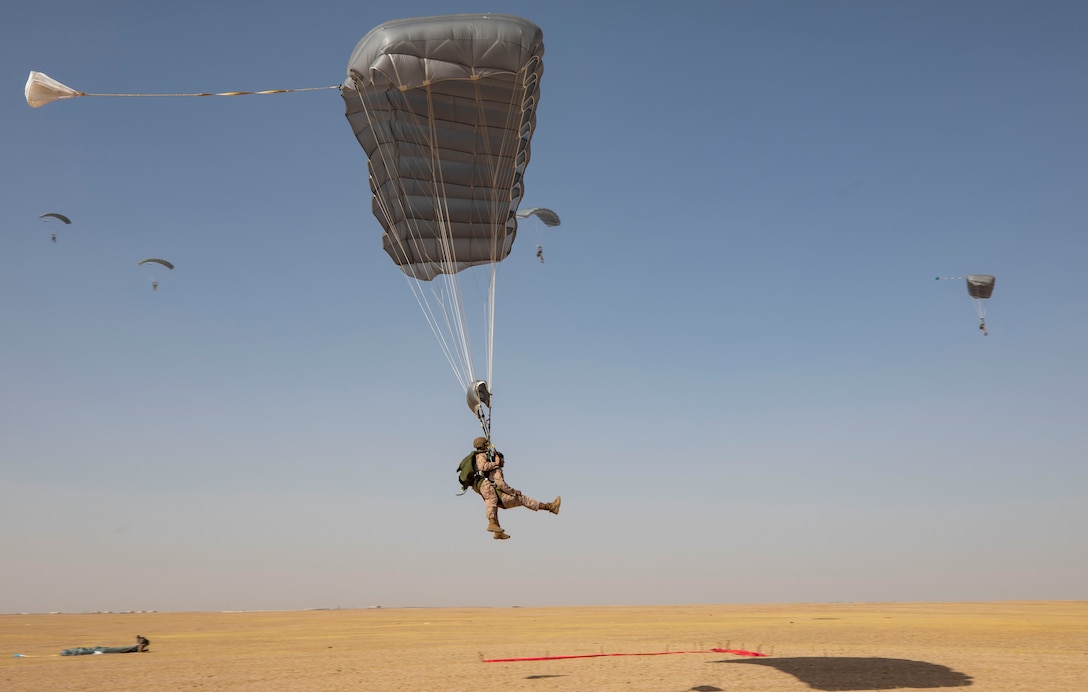 CAMP BEUHRING, Kuwait (April 19, 2019) – U.S. Marine Gunnery Sgt. Patrick Keeling, left, the Maritime Raid Force operations chief, prepares to land with 1st Lt. Austin Ahmed, the platoon commander for the Maritime Raid Force’s 3rd Platoon, both with the 22nd Marine Expeditionary Unit, as part of a tandem freefall jump during Marine Expeditionary Unit Exercise. The training increases parachuting and jumpmaster proficiency, and ensures the Marines maintain combat readiness. Marines and Sailors with the 22nd MEU and Kearsarge Amphibious Ready Group are currently deployed to the U.S. 5th Fleet area of operations in support of naval operations to ensure maritime stability and security in the Central region, connecting the Mediterranean and the Pacific through the western Indian Ocean and three strategic choke points. (U.S. Marine Corps photo by Sgt. Aaron Henson/Released)