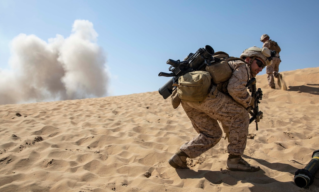 CAMP BEUHRING, Kuwait (April 21, 2019) – U.S. Marine Lance Cpl. Thomas Barry, a gunner with the 22nd Marine Expeditionary Unit, prepares to run over a hill and through a breach as part of Combined Arms Live Fire Exercise during Marine Expeditionary Unit Exercise. Marines and Sailors from the 1st Battalion, 2nd Marine Regiment participated in the training in order to increase proficiency and maintain combat readiness. Marines and Sailors with the 22nd MEU and Kearsarge Amphibious Ready Group are currently deployed to the U.S. 5th Fleet area of operations in support of naval operations to ensure maritime stability and security in the Central region, connecting the Mediterranean and the Pacific through the western Indian Ocean and three strategic choke points. (U.S. Marine Corps photo by Sgt. Aaron Henson/Released)