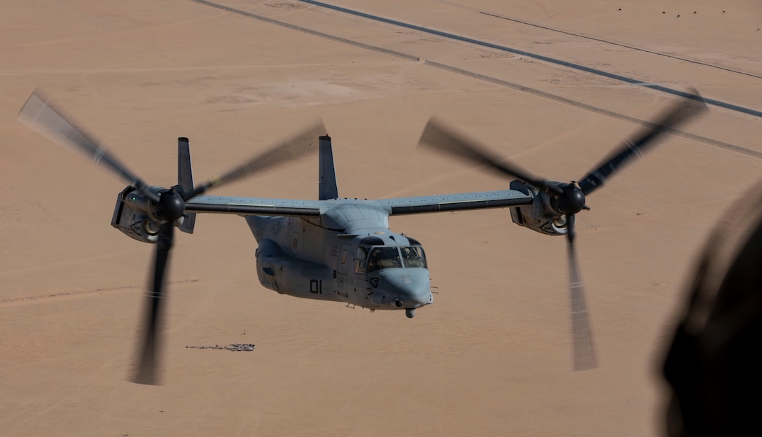 A U.S. Marine MV-22 Osprey with the 22nd Marine Expeditionary Unit flies across the desert with U.S. Army Soldiers as part of an inter-service familiarity flight event during Marine Expeditionary Unit Exercise, April 15, 2019.
