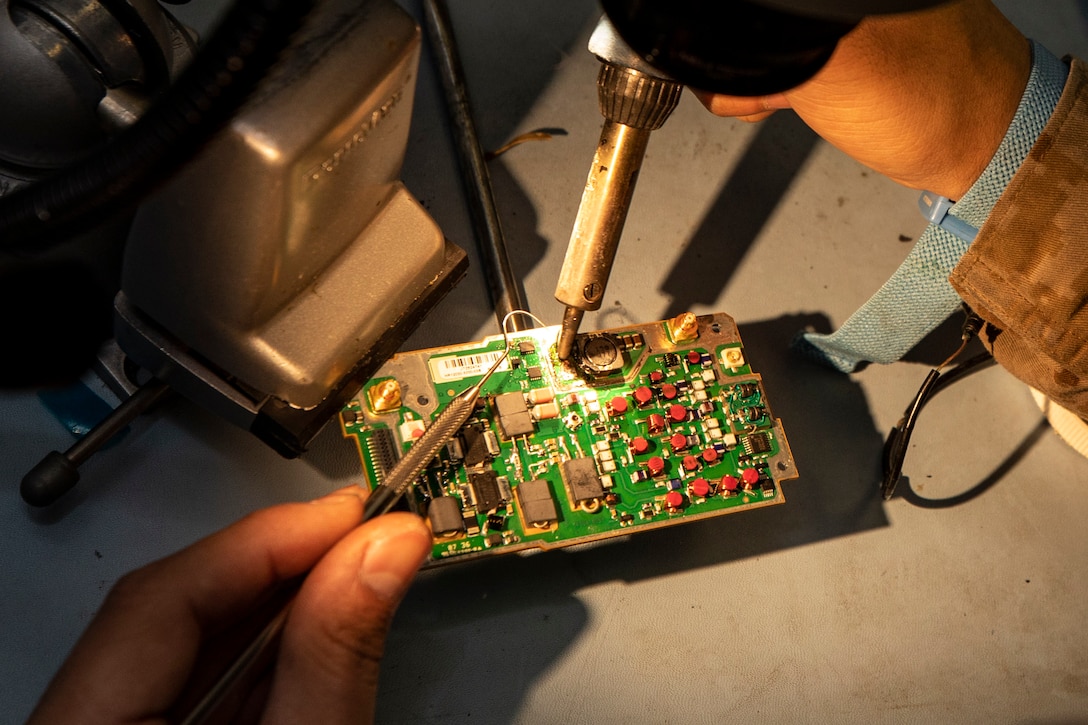 GULF OF ADEN (March 24, 2019) – U.S. Marine Cpl. Jacob Bautista, a micro-miniature repairman with the 22nd Marine Expeditionary Unit, cleans off a radio circuit board after removing a burnt capacitor aboard the Wasp-class amphibious assault ship USS Kearsarge (LHD-3). Marines routinely check gear and perform maintenance in order to maintain operational readiness. Marines and Sailors with the 22nd MEU and Kearsarge Amphibious Ready Group are currently deployed to the U.S. 5th Fleet area of operations in support of naval operations to ensure maritime stability and security in the Central region, connecting the Mediterranean and the Pacific through the western Indian Ocean and three strategic choke points. (U.S. Marine Corps photo by Sgt. Aaron Henson/Released)
