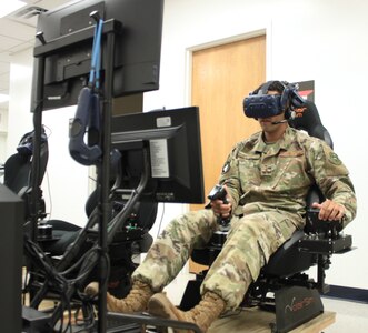 U.S. Air Force 2nd Lt. Isaac Perez flies a training sortie on a virtual reality simulator at Air Education and Training Command’s Det. 24 at Joint Base San Antonio-Randolph Aug. 20. Perez, who is awaiting the start of version three of “Pilot Training Next,” was the 2019 winner of the Intercollegiate Tennis Association’s national Arthur Ashe Jr. Leadership and Sportsmanship award.