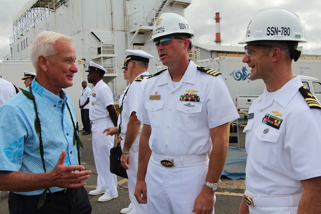 Mayor Kirk Caldwell (left) gets acquianted with CDR George Howell, USS MISSOURI (SSN-780) Commanding Officer, and LCDR Jeremy Nauta, USS MISSOURI (SSN-780) Executive Officer, at the Pearl Harbor Naval Shipyard’s centennial anniversary of Dry Dock One on Aug. 21, 2019, at Dry Dock One.