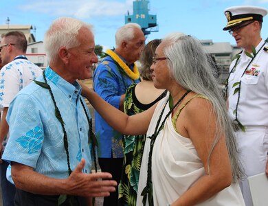Mayor Kirk Caldwell (left) is greeted by Aunty Kehaulani Lum, an Ali'i Pauahi Hawaii Civic Club member, at the Pearl Harbor Naval Shipyard’s centennial anniversary of Dry Dock One on Aug. 21, 2019, at Dry Dock One.