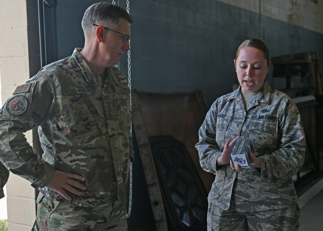 U.S. Air Force Tech. Sgt. Cynthia Ward, 7th Equipment Maintenance Squadron aircrew ground equipment production support NCO in charge, shows a prototype AGE asset tracking system to Gen. Tim Ray, Commander of Air Force Global Strike Command, at Dyess Air Force Base, Texas, Aug. 22, 2019. The tracking system is a new innovation designed to keep account of individual pieces of equipment to assist in AGE inventory processes. (U.S. Air Force photo by Senior Airman Susan Roberts)