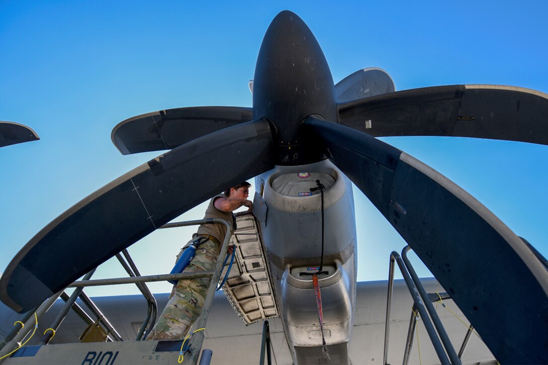 An airman works on an engine.