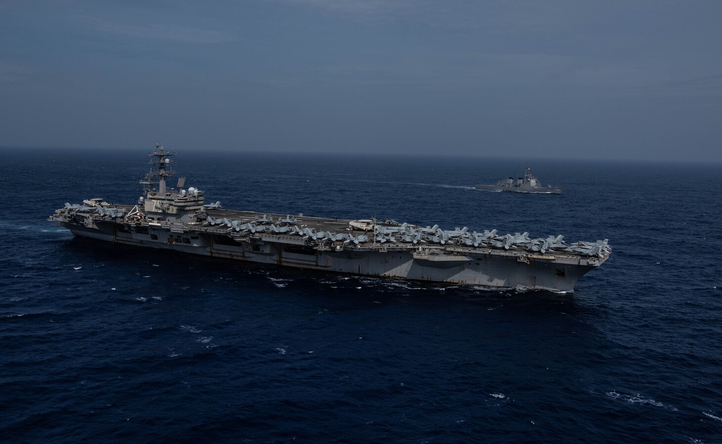 PHILIPPINE SEA (August 15, 2019) The Navy’s forward-deployed aircraft carrier USS Ronald Reagan (CVN 76) sails alongside the Japan Maritime Self-Defense Force guided-missile destroyer JS Myoko (DDG-175) while underway. The Navy and JMSDF regularly operate, train and exercise together to improve interoperability and strengthen joint capabilities. Ronald Reagan, the flagship of Carrier Strike Group 5, provides a combat-ready force that protects and defends the collective maritime interests of its allies and partners in the Indo-Pacific region.