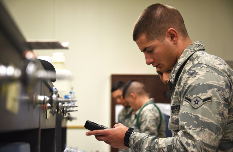 366th Training Squadron water and fuels systems maintenance course student uses a pocket colorimeter to perform a chlorine test