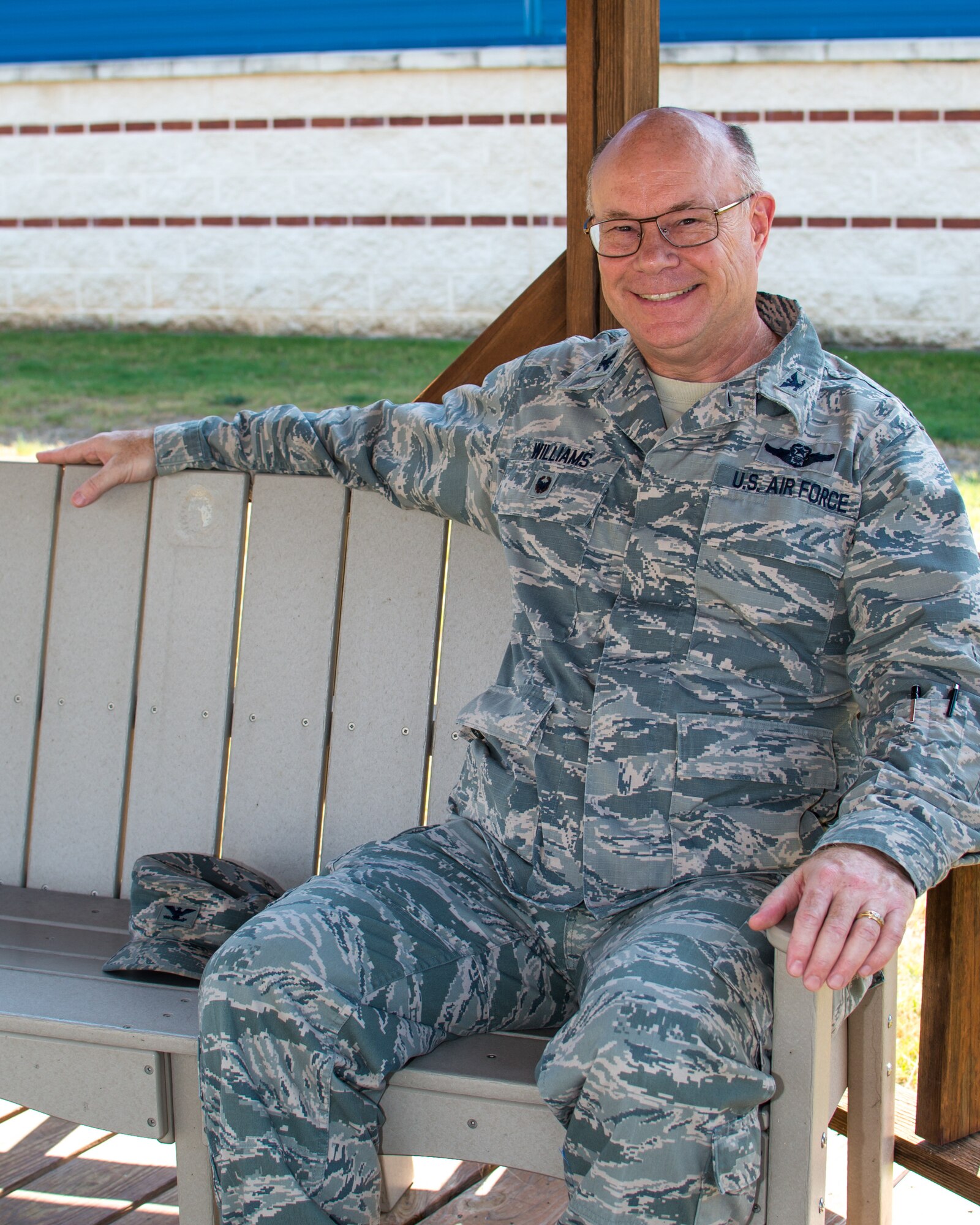 Col. Keith Williams, 136th Airlift Wing Vice Commander, takes a quick break on a bench outside the headquarters building.