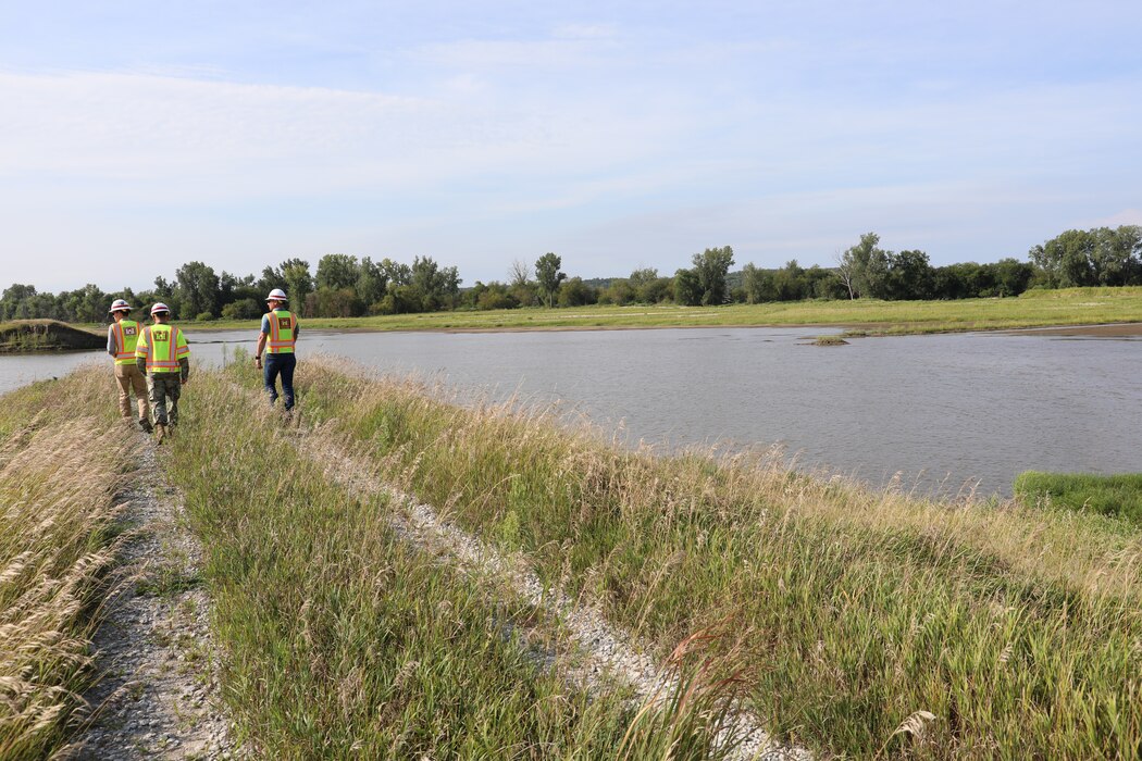 Col. John Hudson and USACE Omaha District employees review progress on Levee L611-614 near Council Bluffs, Iowa Aug. 23, 2019.