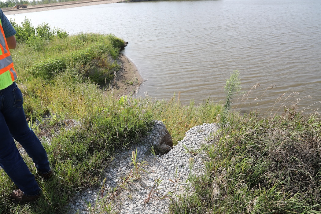 Col. John Hudson and USACE Omaha District employees review progress on Levee L611-614 near Council Bluffs, Iowa Aug. 23, 2019.