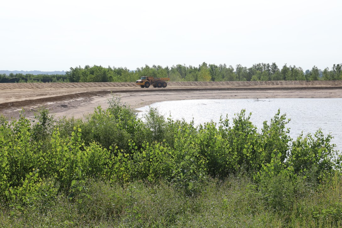 Col. John Hudson and USACE Omaha District employees review progress on Levee L611-614 near Council Bluffs, Iowa Aug. 23, 2019.