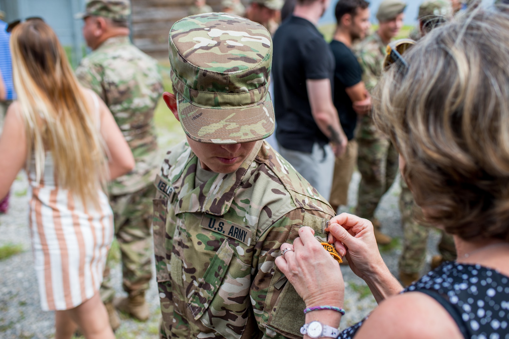 Staff Sgt. Amanda F. Kelley (left), assigned to the 1st Armored Division’s combat aviation brigade at Fort Bliss, Texas, gets her Ranger tab pinned on by a family member during her Ranger School graduation at Fort Benning, Georgia, Aug. 31, 2018. Kelley is the first enlisted woman to earn the Ranger tab.