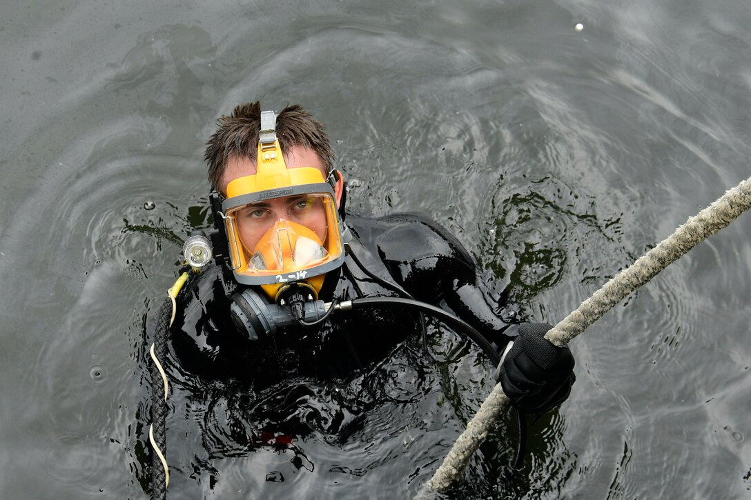 A diver emerges from the water.