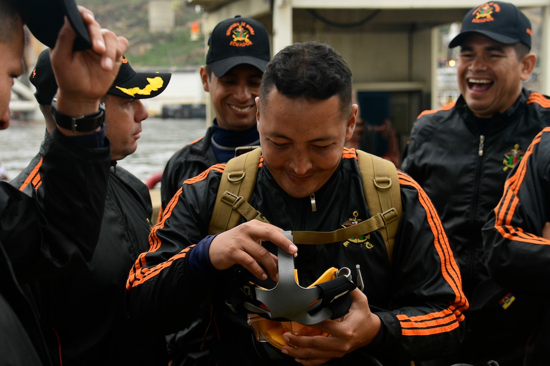An Ecuadorian Navy diver examines an MK-20 dive mask.