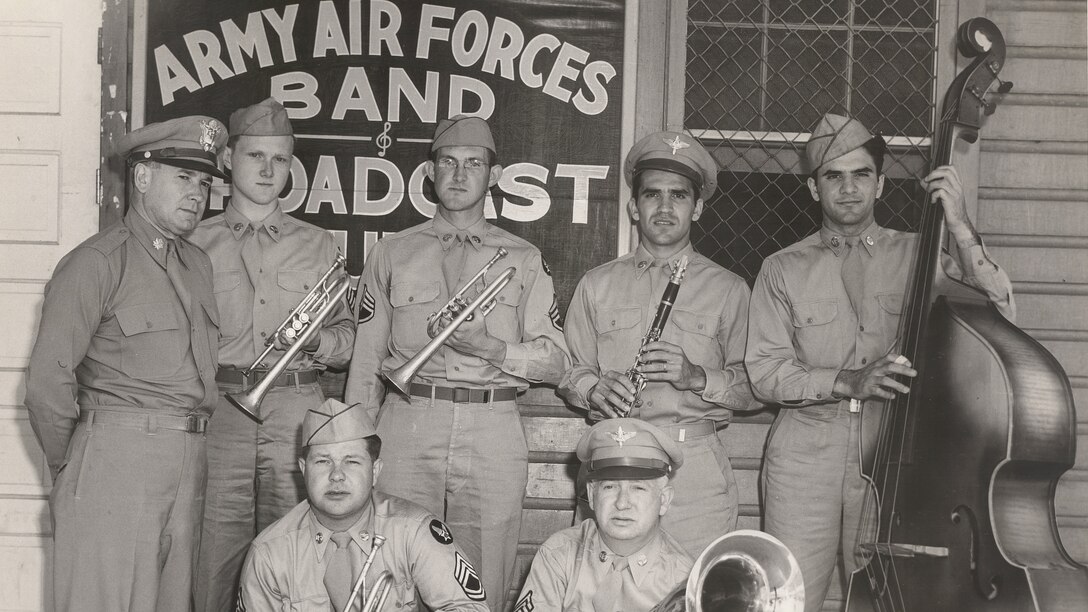 Members of the Army Air Corps Band pose for a photo after being broadcast to military members around the world. When the band recorded, the sound was captured on large recording lathes and a master vinyl disc was cut directly from the transmission.