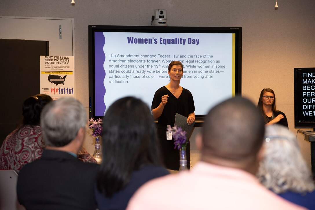 Defense Logistics Agency associate and guest speaker Natalie Thurston provides some historical reference to the journey and challenges that women have triumphed over to secure the right to vote.