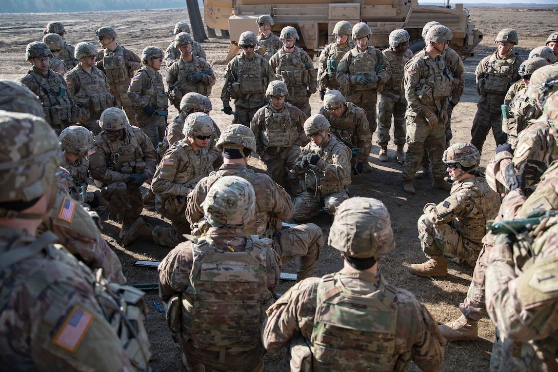 Soldiers gather in a training area.