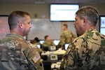 Maj. Daniel Mueller, chief of operations for the Vigilant Guard 19-4 Joint Task Force, explains the disaster response exercise to Brig. Gen. Laszlo Garas, director of joint operations for the Hungarian Defence Forces, Aug. 5, 2019, in Springfield, Ohio. Vigilant Guard provides civil-military first responders and emergency management personnel the opportunity to evaluate their capabilities to react to an actual man-made or natural disaster. Ohio has been paired with Hungary through the State Partnership Program since 1993.