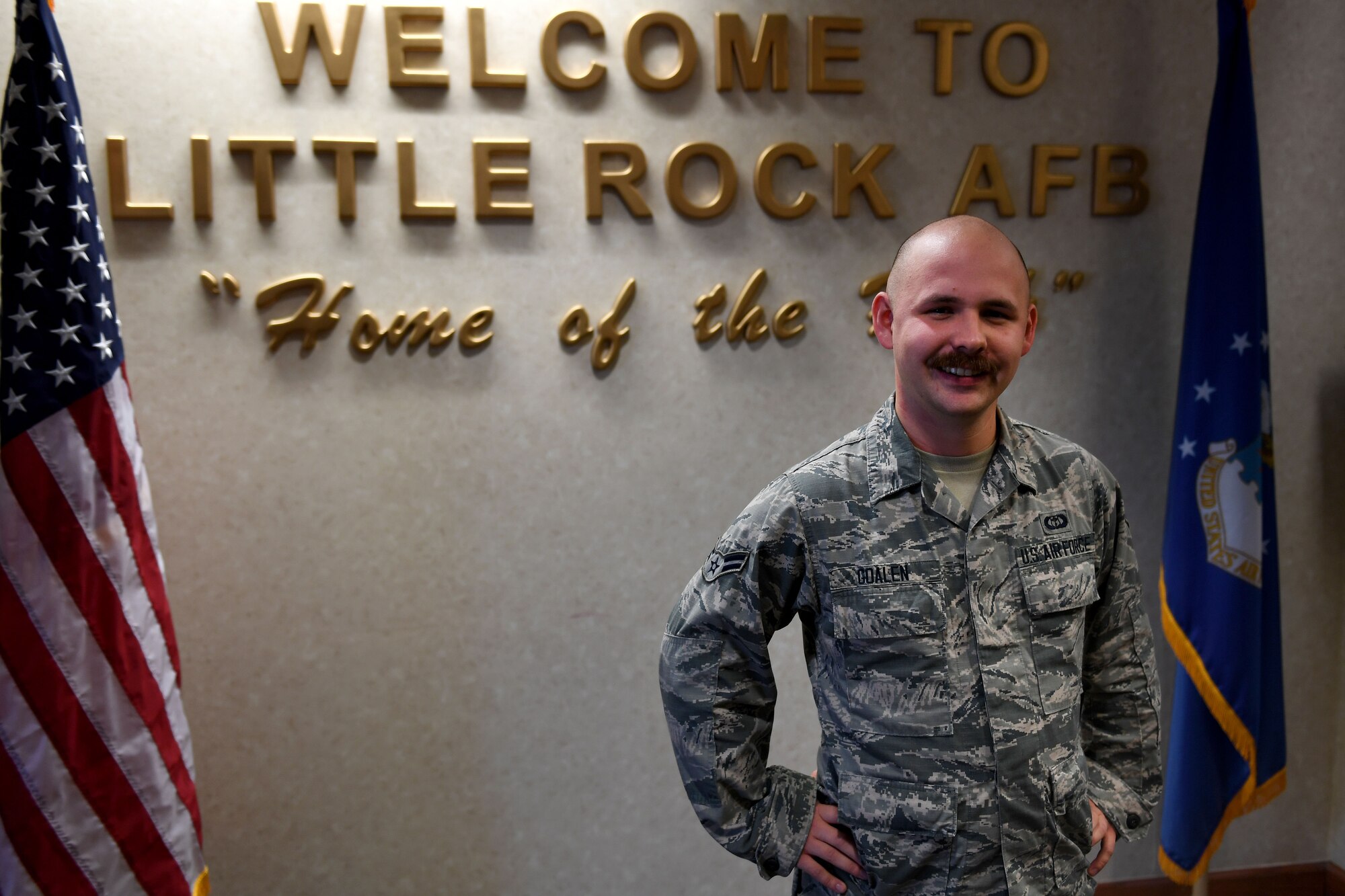 A man stands in front of a sign.
