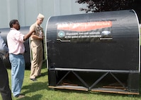 Garry Shields, director of the Disruptive Technologies Lab at Naval Surface Warfare Center, Carderock Division, shows the Optionally Manned Technology Demonstrator to Capt. Pete Small, head of Naval Sea Systems Command’s Unmanned Maritime Systems (PMS 406), during his visit to Carderock’s West Bethesda, Md., site on Aug. 16, 2019. Small was at Carderock to get an overview of Carderock’s unmanned portfolio and capabilities. (U.S. Navy photo by James Contreras/Released)