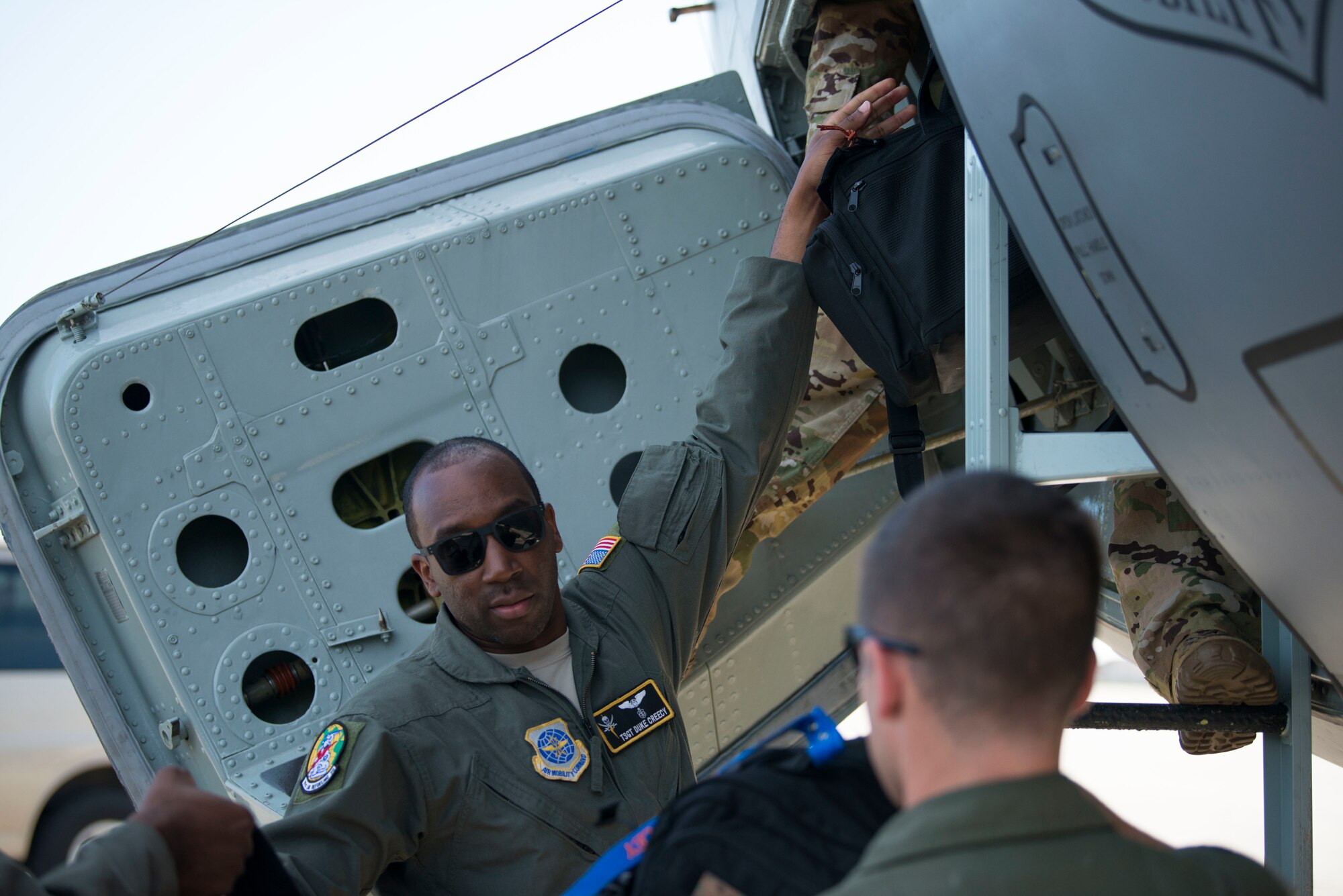 U.S. Air Force Tech. Sgt. Johnnie Creecy, a 91st Air Refueling Squadron flight chief, hands gear up to a KC-135 Stratotanker pilot during pre-flight duties at MacDill Air Force Base, Fla., Aug. 21, 2019. Pre-flight checks are performed to verify the aircraft is ready to fly. (U.S. Air Force photo by Senior Airman Frank Rohrig)