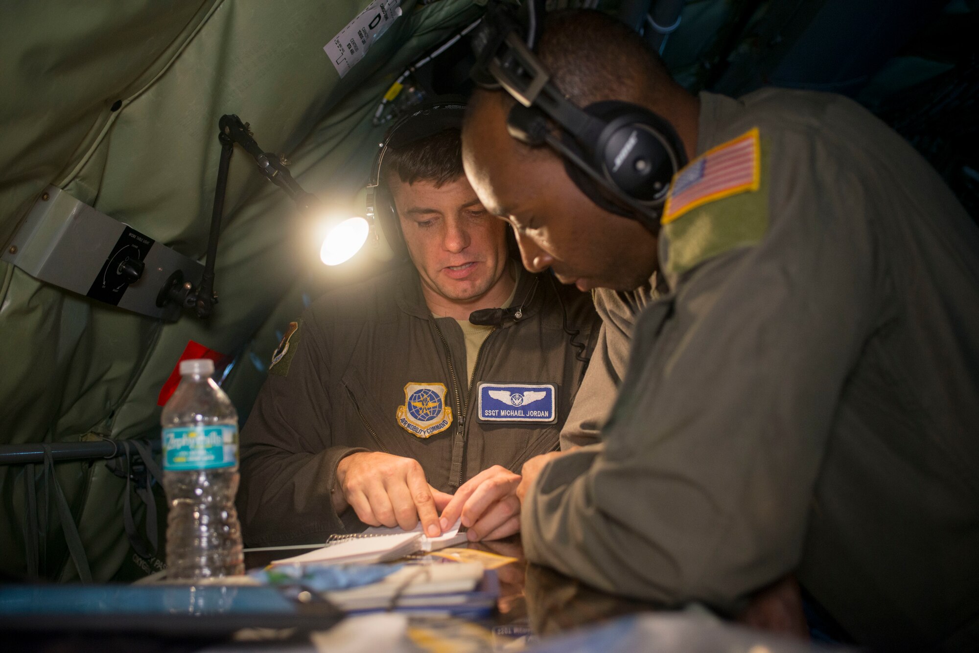 U.S. Air Force Staff Sgt. Michael Jordan, a 91st Air Refueling Squadron boom operator and Tech. Sgt. Johnnie Creecy, a 91st ARS flight chief, reviews instructor training procedures inside a KC-135 Stratotanker, Aug. 21, 2019. Instructors and boom operators review procedures to ensure strict compliance during mission accomplishment. (U.S. Air Force photo by Senior Airman Frank Rohrig)