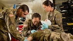 Lt. Col. Juli Fung-Hayes (center), a U.S. Army Reserve emergency medicine physician with the 2nd Medical Brigade, leads a medic team from the 396th Combat Support Hospital, headquartered at Fairchild Air Force Base, Washington, through a trauma and critical care scenario in a field hospital during a promotional photo shoot for Army Reserve marketing and recruiting at Fort Hunter Liggett, California, July 18, 2018.