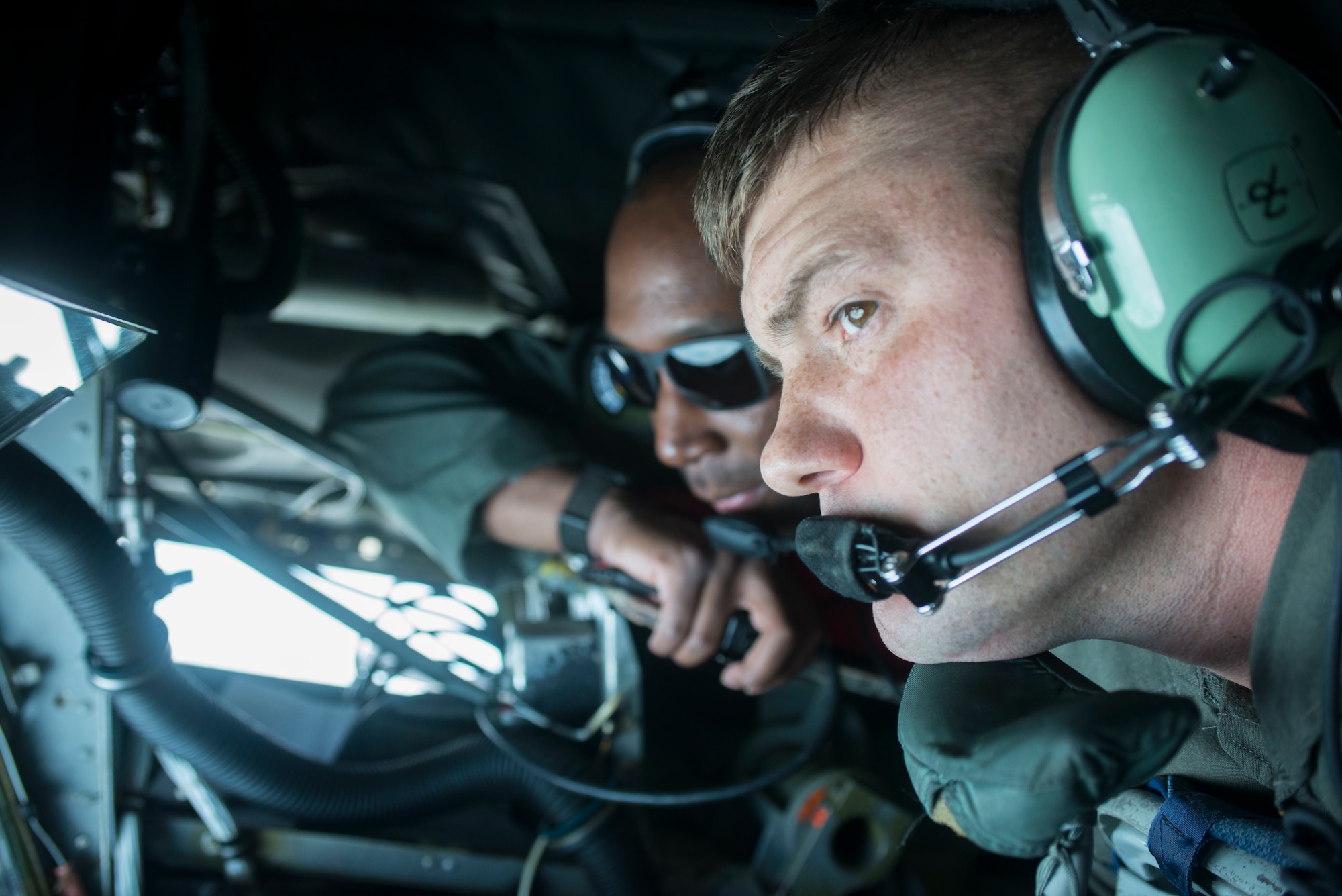U.S. Air Force Staff Sgt. Michael Jordan, a 91st Air Refueling Squadron boom operator and Tech. Sgt. Johnnie Creecy, a 91st ARS flight chief, wait in the boom pod of a KC-135 Stratotanker for the receiver to approach Aug. 21, 2019. A receiver is any aircraft that receives fuel from a tanker during flight. (U.S. Air Force photo by Senior Airman Frank Rohrig)