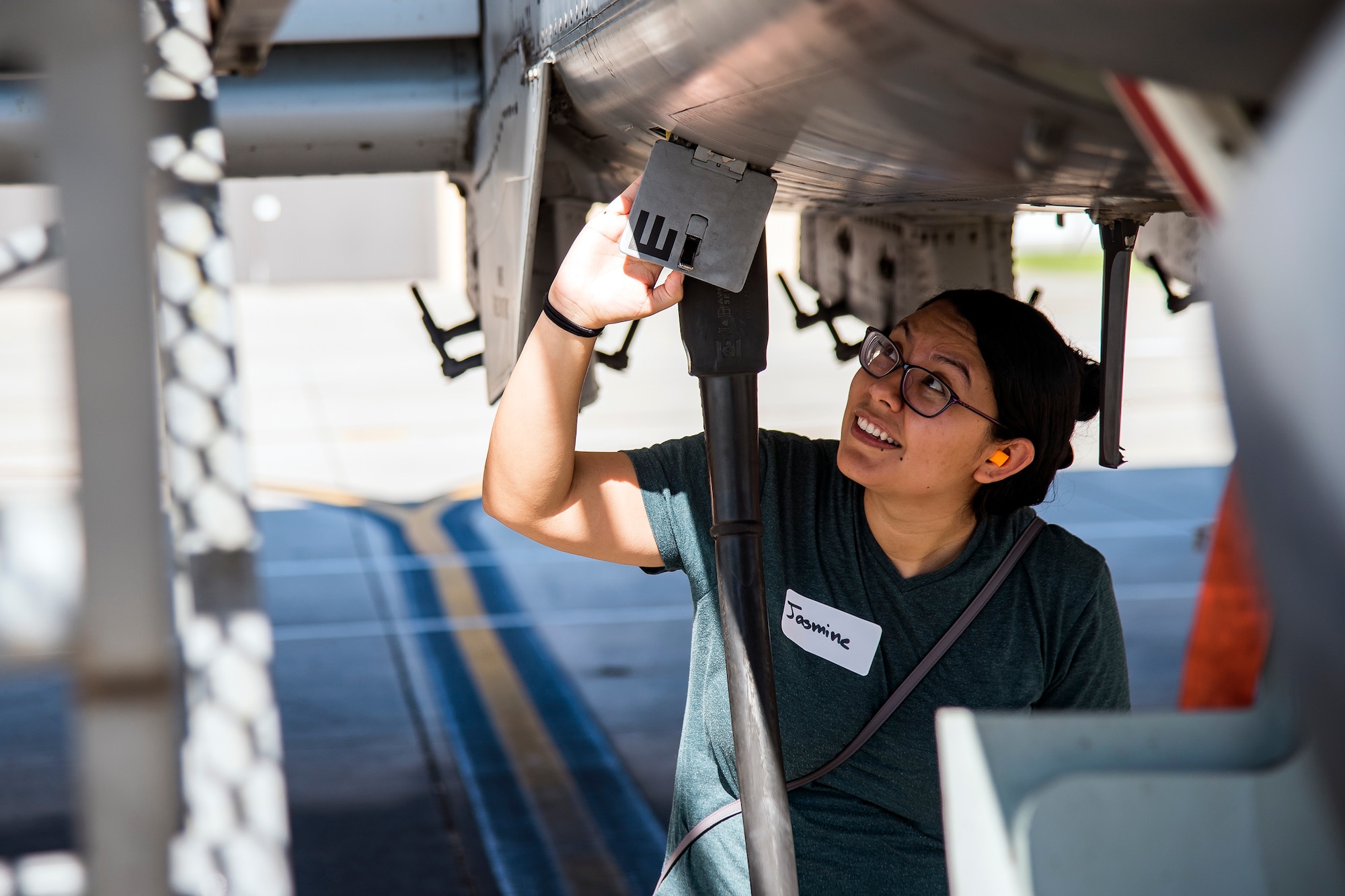 A Team Moody spouse observes the panel underneath an A-10C Thunderbolt II Aug. 23, 2019, at Moody Air Force Base, Ga. Spouses and family members from the 23d Aircraft Maintenance Squadron toured the squadron and flightline to gain a first-hand understanding of what role their significant other plays in the mission. The tour also served as a way to expand support networks by connecting spouses and family members with unit personnel. (U.S. Air Force photo by Airman 1st Class Eugene Oliver)