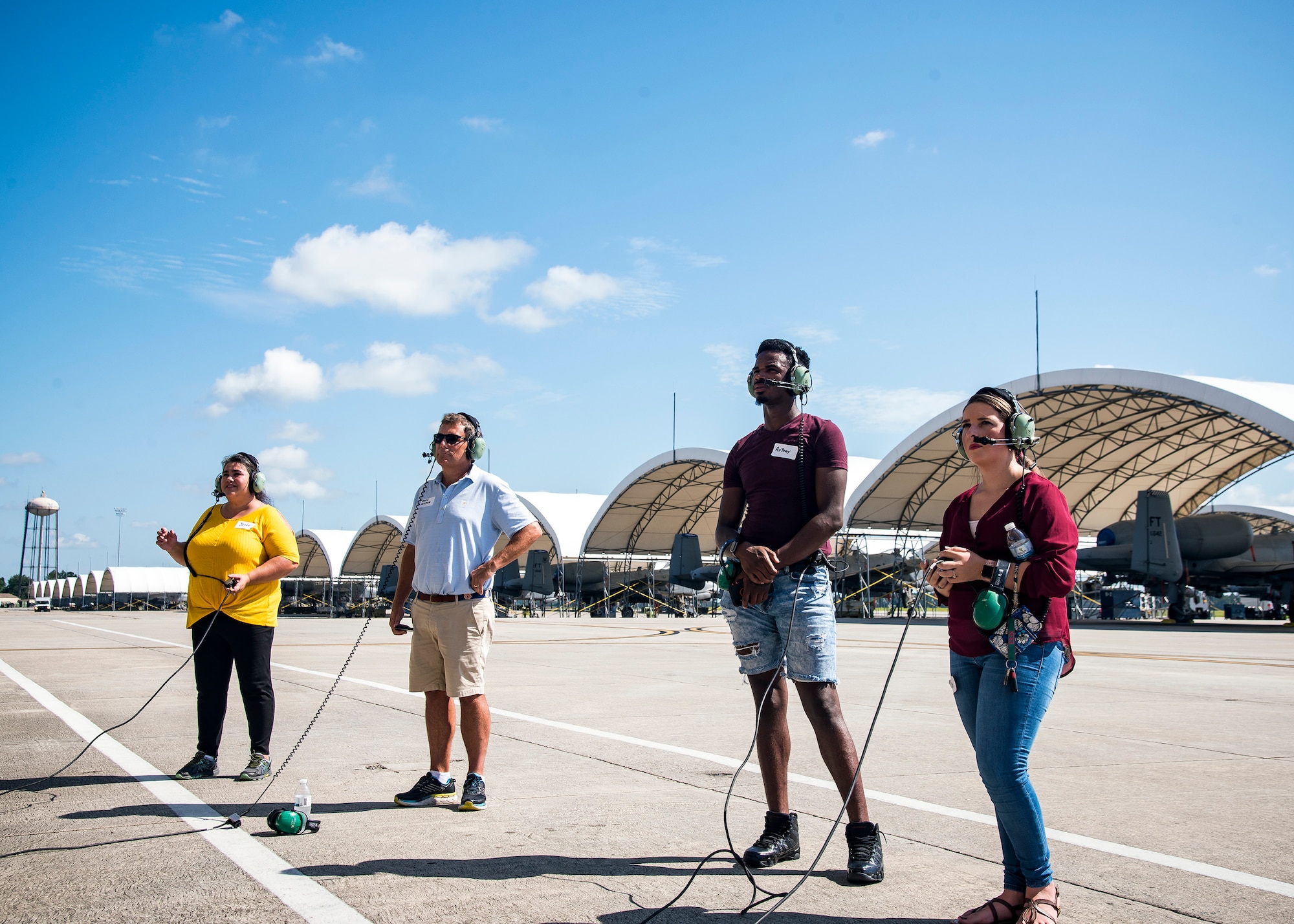 Team Moody spouses and family members stand on the flightline Aug. 23, 2019, at Moody Air Force Base, Ga. Spouses and family members from the 23d Aircraft Maintenance Squadron toured the squadron and flightline to gain a first-hand understanding of what role their significant other plays in the mission. The tour also served as a way to expand support networks by connecting spouses and family members with unit personnel. (U.S. Air Force photo by Airman 1st Class Eugene Oliver)