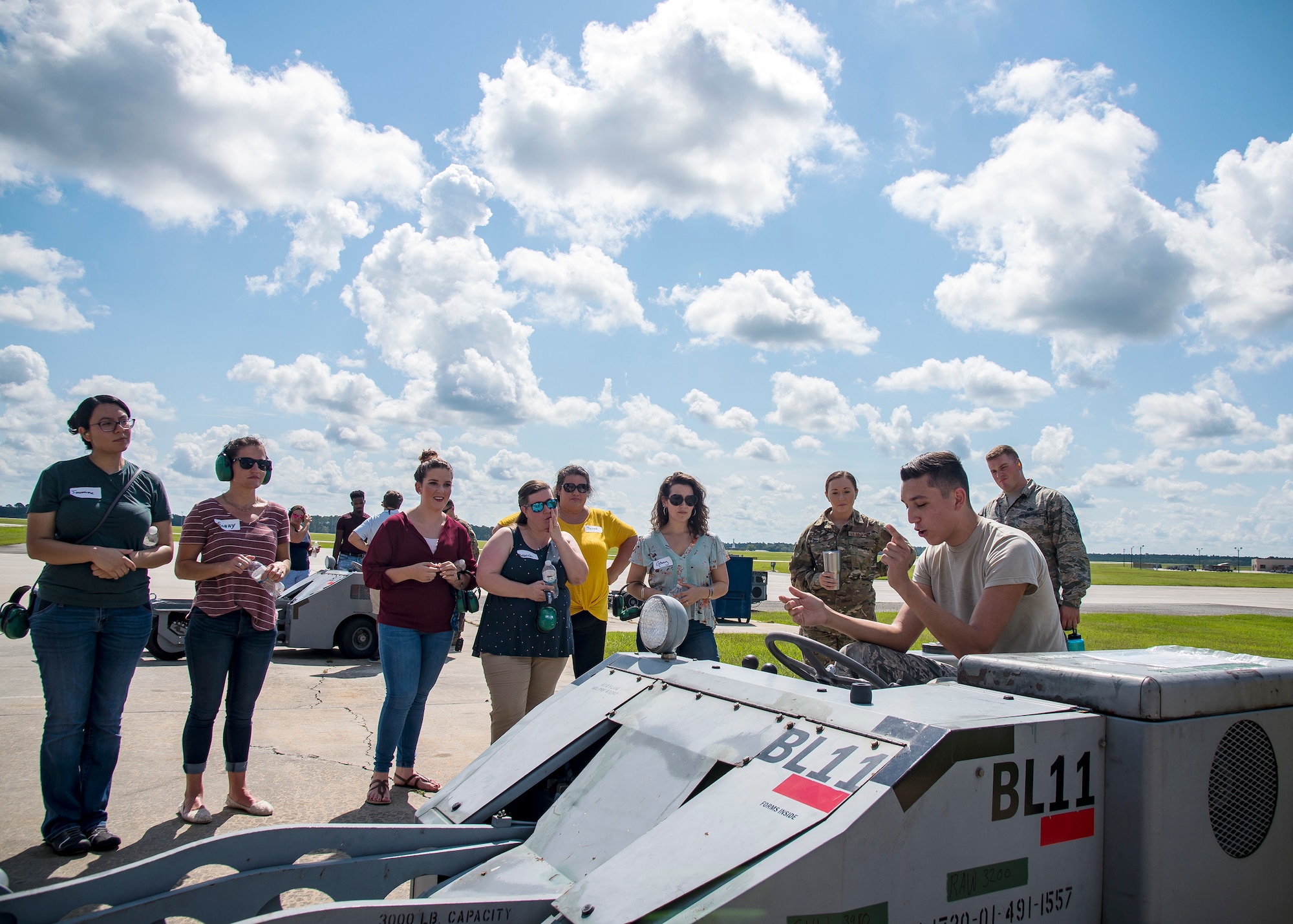An Airman from the 23d Aircraft Maintenance Squadron (AMXS), front, speaks to Team Moody spouses and family members Aug. 23, 2019, at Moody Air Force Base, Ga. Spouses and family members from the 23d AMXS toured the squadron and flightline to gain a first-hand understanding of what role their significant other plays in the mission. The tour also served as a way to expand support networks by connecting spouses and family members with unit personnel. (U.S. Air Force photo by Airman 1st Class Eugene Oliver)