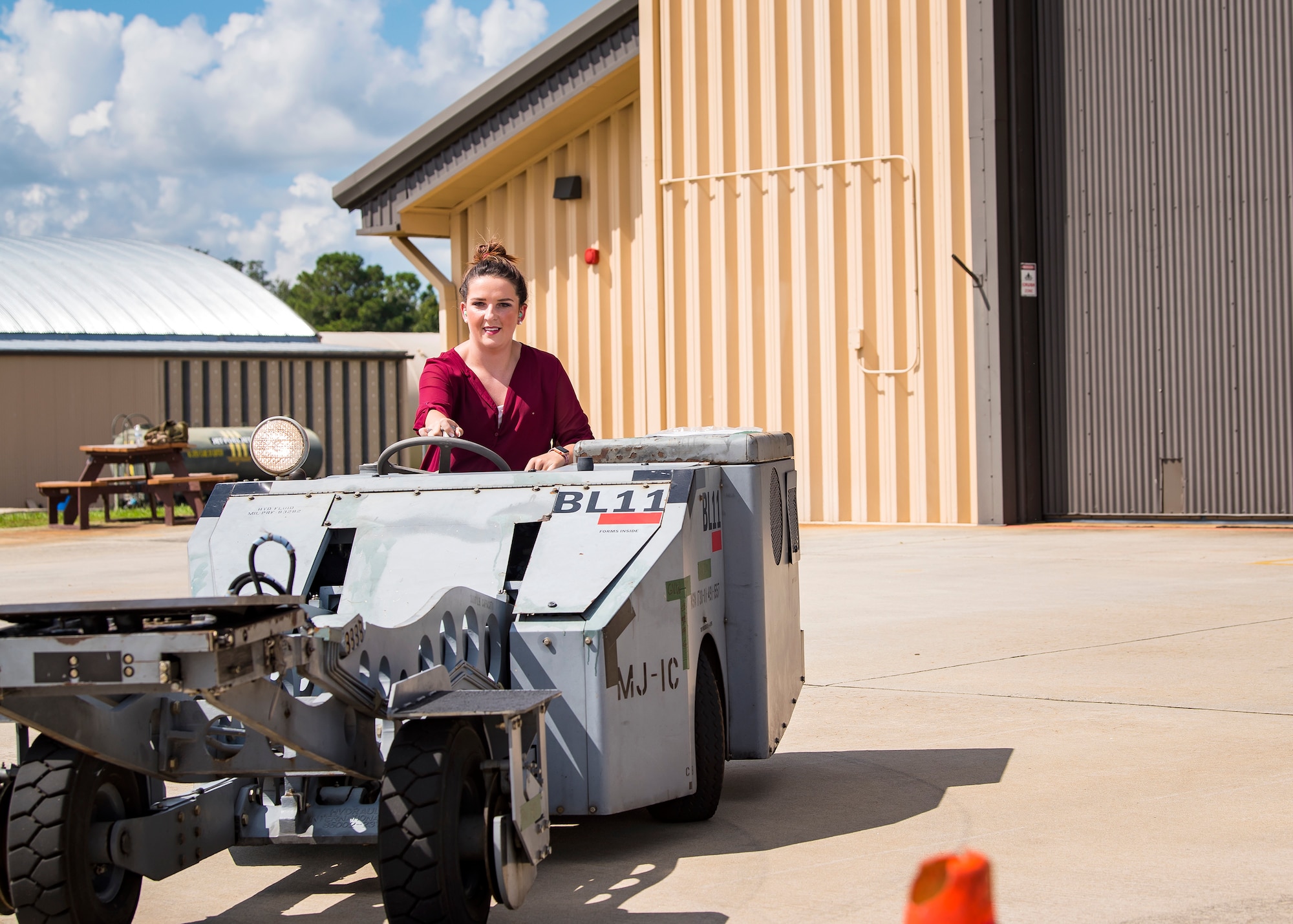 A Team Moody spouse operates a MJ1-B munition handler Aug. 23, 2019, at Moody Air Force Base, Ga. Spouses and family members from the 23d Aircraft Maintenance Squadron (AMXS) toured the squadron and flightline to gain a first-hand understanding of what role their significant other plays in the mission. The tour also served as a way to expand support networks by connecting spouses and family members with unit personnel. (U.S. Air Force photo by Airman 1st Class Eugene Oliver)